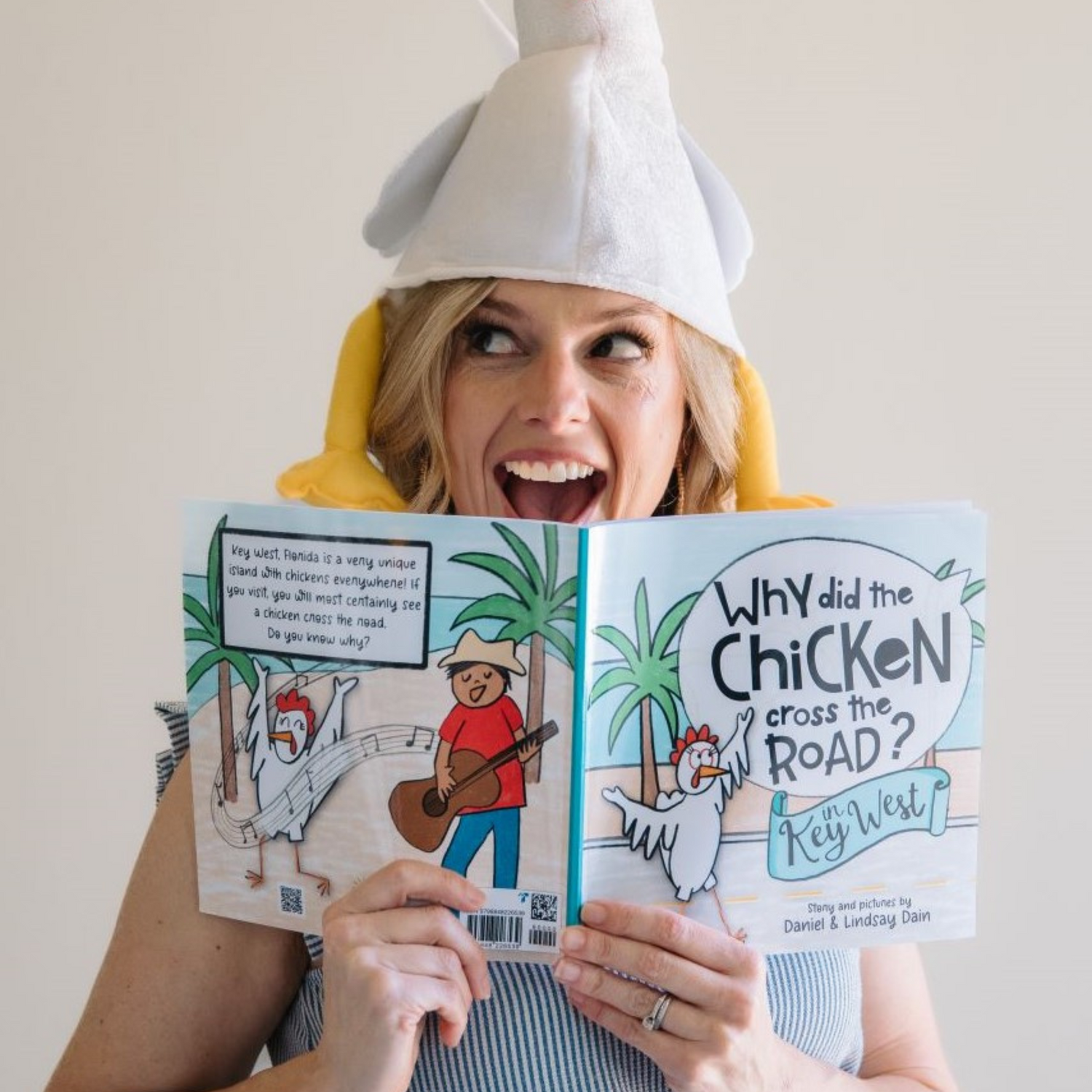 Self-Published author and illustrator Lindsay Dain holding her book titled "Why Did the Chicken Cross the Road in Key West?" created on Amazon KDP