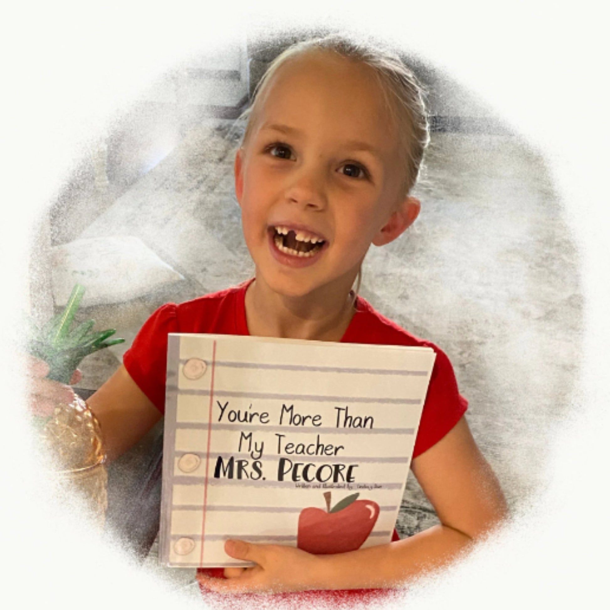 Gift certificate photo of a proud, happy, young girl holding the self-published personalized book called “You’re More Than My Teacher”
